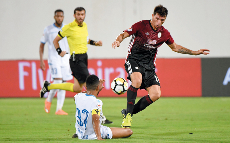 لاعب الوحدة، الأرجنتيني تيغالي، أضاع هدفاً غريباً أمام حتا، وفي الصورة يسعى لاستخلاص الكرة من محمود حسن. تصوير: إريك أرازاس