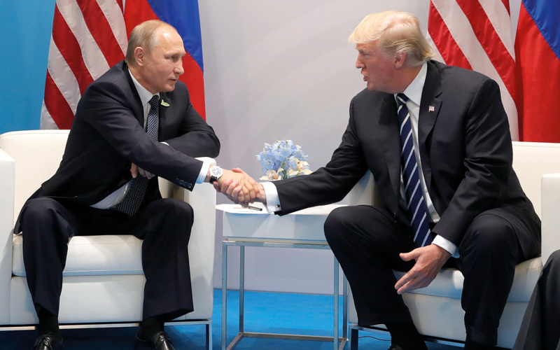 U.S. President Donald Trump, right, and Russian President Vladimir Putin shake handsduring the G20 summit in Hamburg Germany, Friday July 7, 2017. (Mikhail Klimentyev, Kremlin Pool Photo via AP)