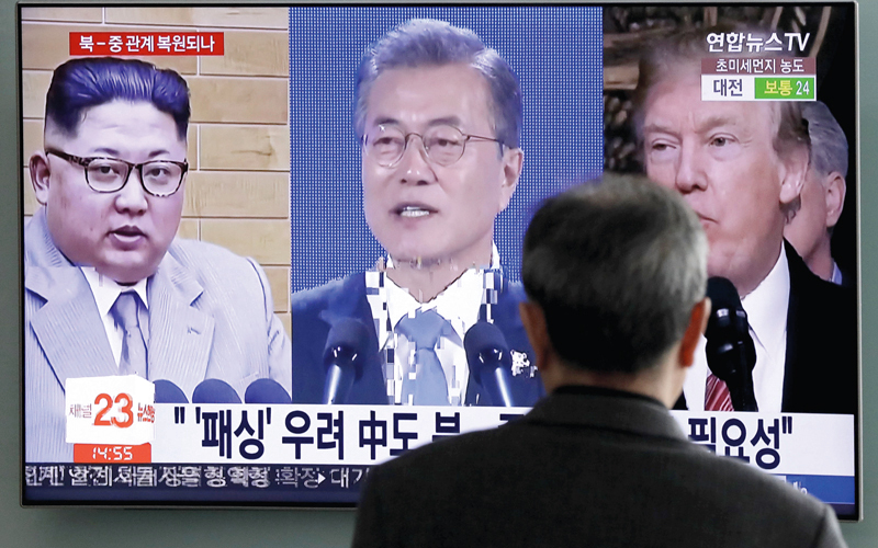 صورة تلفزيونية يبدو من خلالها كلٌ من الزعيم الكوري الشمالي والرئيس الكوري الجنوبي والرئيس الأميركي.  أ.ب