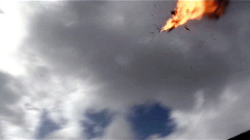 «الدرون» الحوثية لحظة انفجارها فوق منصة العرض العسكري.  أ.ف.ب