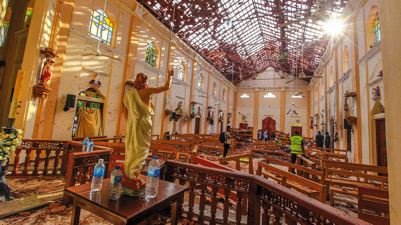 مسؤولون يتفقدون أحد مواقع التفجيرات داخل كنيسة. أسوشيتد برس