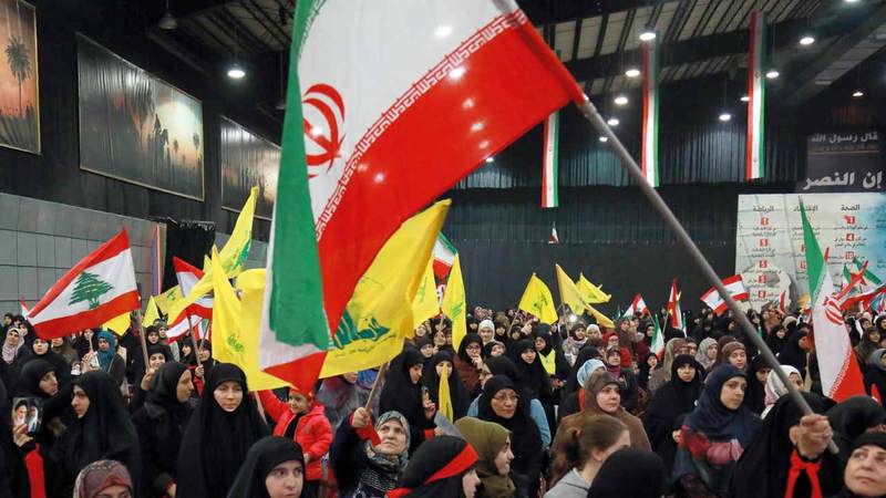 أنصار «حزب الله» في بيروت يرفعون علم الحزب والعلم الإيراني احتفالاً بالذكرى السنوية الـ40 للثورة الإيرانية.  أ.ف.ب