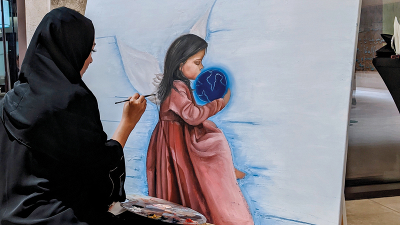 الفنانة الإماراتية أمل لوتاه تشارك  بـ3 لوحات إحداها تمثل فتاة تجلس على شاطئ البحر وقامت برسمها أمام الجمهور. من المصدر
