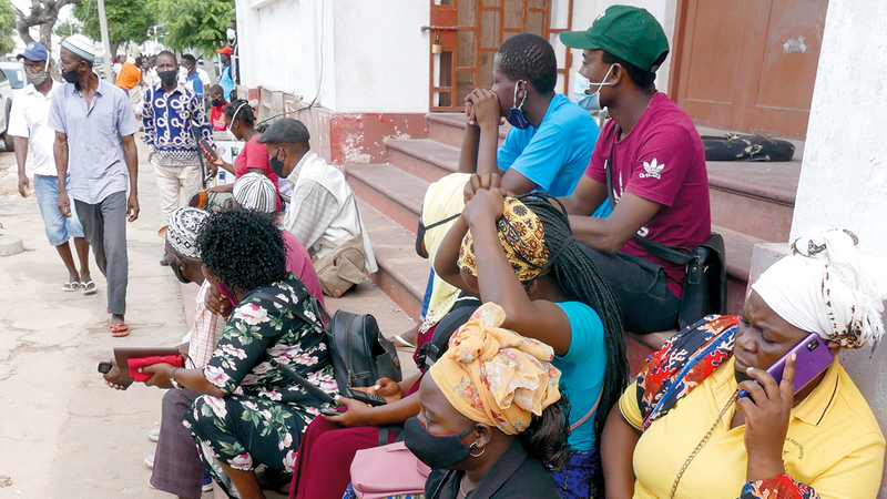 مواطنون ينتظرون وصول القوارب من بالما محملة بالناس الهاربين من جرائم «داعش» في بيمبا. اي.بي.ايه