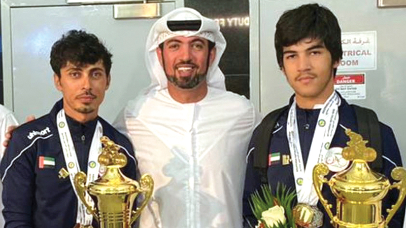 الأب أحمد المطيوعي برفقة ابنه محمد المتوج بذهبية البطولة العربية للدرّاجات.   من المصدر