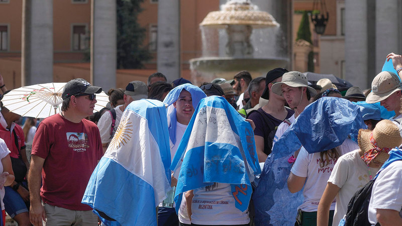 سياح يغطون رؤوسهم جراء الحرارة الشديدة في الفاتيكان.   أ.ب