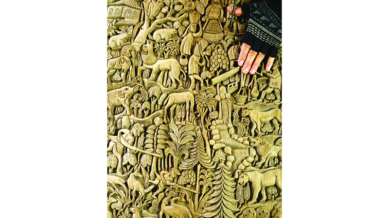 Wood carving artisan Ghulam Nabi Dar crafts designs on a wooden piece, at his workshop in Srinagar on February 18, 2025. (Photo by Tauseef MUSTAFA / AFP)