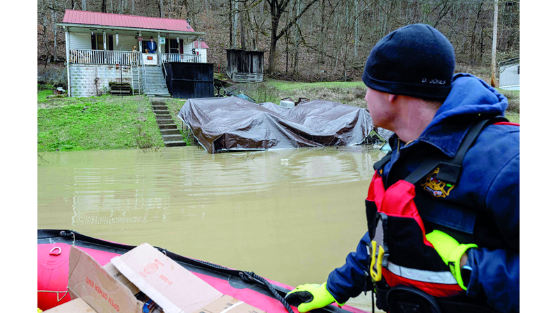 أحد عناصر الإنقاذ يقدم الدعم للعائلات المحاصرة. أ.ف.ب
