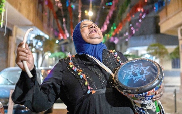 الصورة: المسحراتية &laquo;دلال&raquo;.. بطبلتها وفخرها توقظ الصائمين في القاهرة