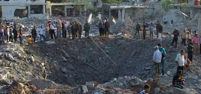 صورة بثّتها «سانا» تظهر آثار تفجير السيارة المفخّخة في قرية الحرة بريف حماة. رويترز