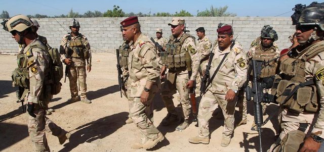 ضباط من قيادة عمليات بغداد يشاركون في المعارك مع «داعش» في منطقة الكرمة شرق الأنبار.  أ.ف.ب