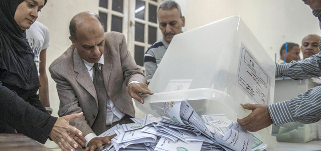 مسؤولون انتخابيون يواصلون عملية حصر الأصوات في نهاية الجولة الأولى من الانتخابات البرلمانية. أ.ف.ب