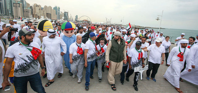 أحمد بن محمد خلال مشاركته في مسيرة اليوم الوطني التي انطلقت من منطقة كاسر الأمواج بالميناء السياحي. تصوير: أشوك فيرما