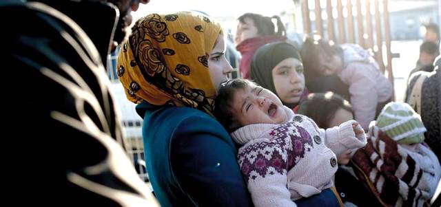 حشود من اللاجئين السوريين عند بوابة بلدة كليس التركية على حدود سورية. أ.ب