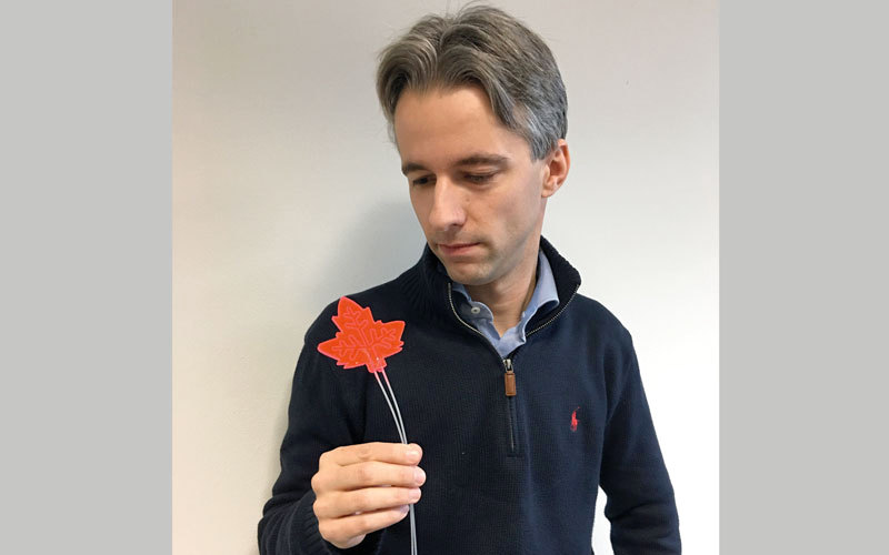 تيموثي نويل يحمل نموذجاً للورقة الاصطناعية. رويترز